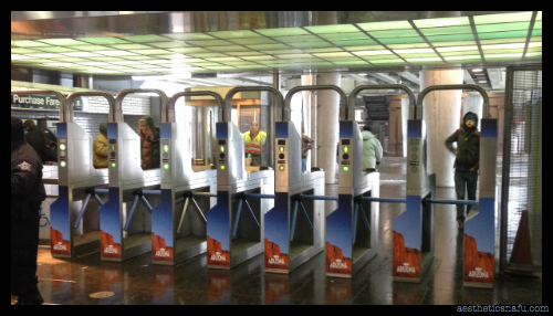 picture of CTA turnstiles with ads for Arizona